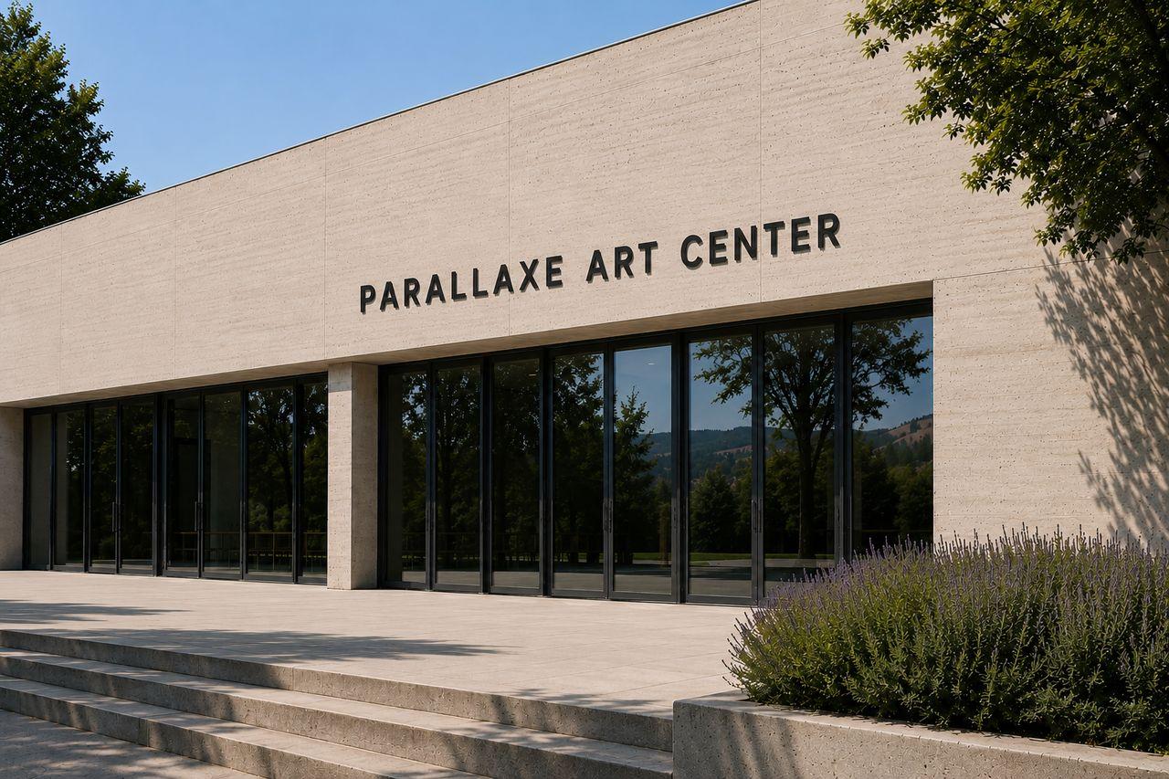 Main view of the Parallaxe façade, combining pale concrete, a glazed entrance and weathered steel.